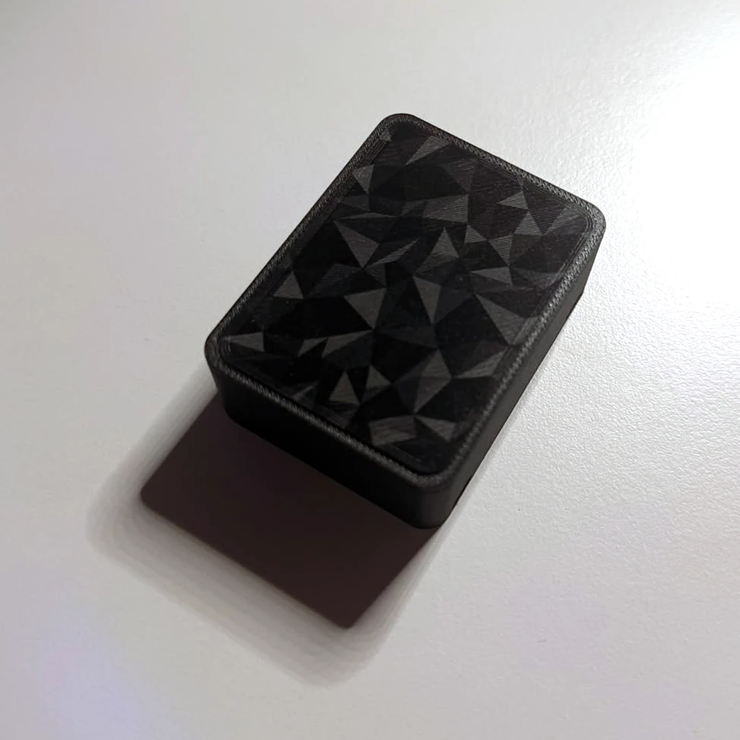 Real photo of the Sentrix tracker, matte black with no logo