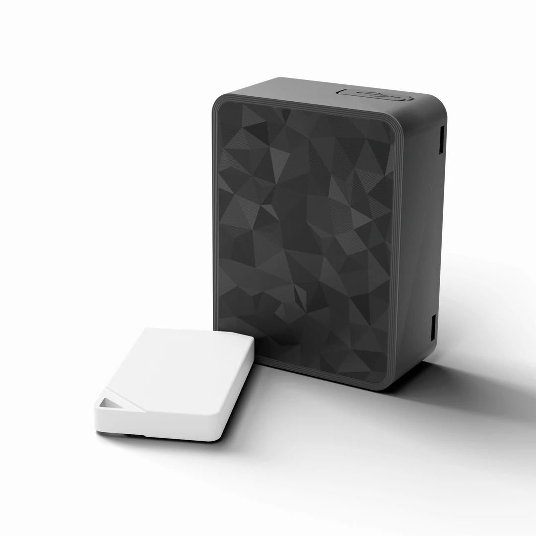 Sentrix next to the white fob it pairs with